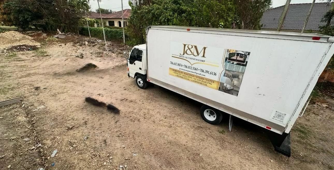 The J & M truck with its services sign: pergolas, railings, stairs, gates, fences and balconies